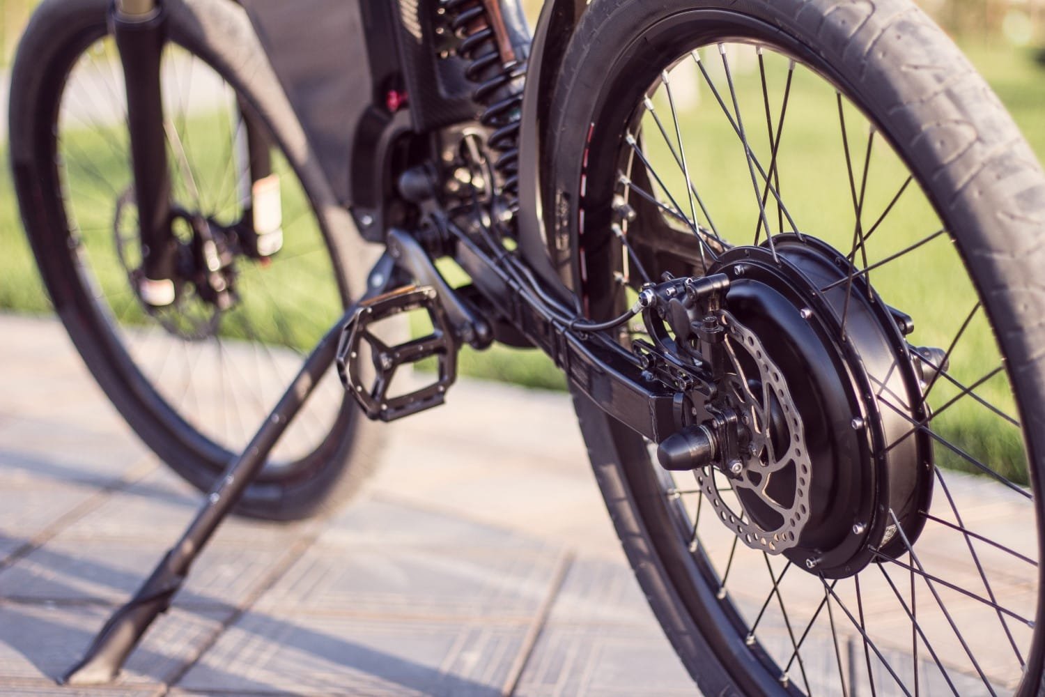 Electric bike motor wheel close up with pedal and rear shock absorber E-Bike Classifications