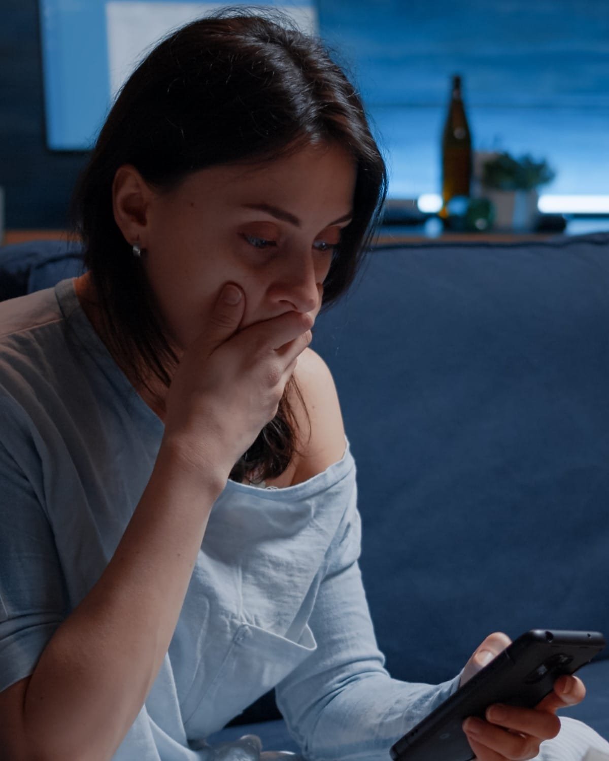 Shocked, worried woman by warning notification for unpaid bank bills
